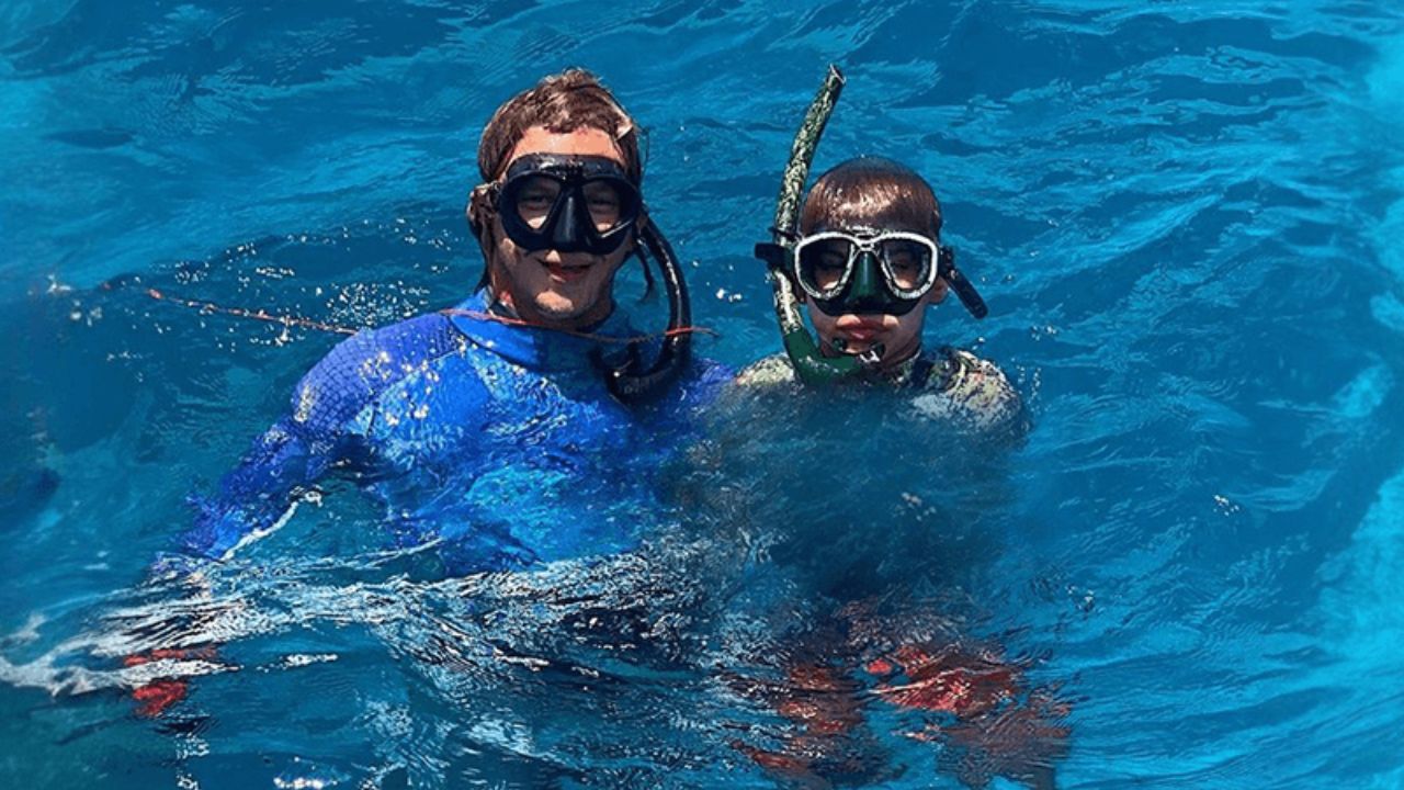 Two snorkelers enjoying Alligator Reef snorkeling in clear blue water near Islamorada, Florida Keys.