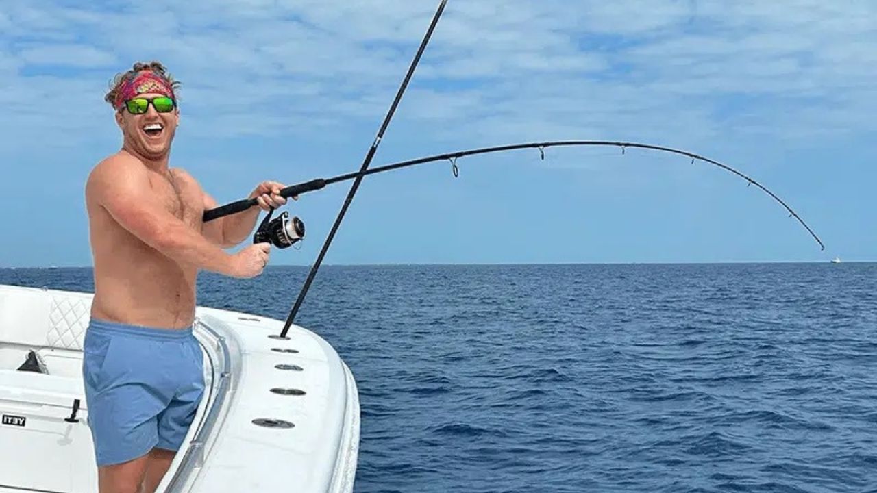 Angler reeling in a fish from a charter boat on the open water in the Florida Keys.