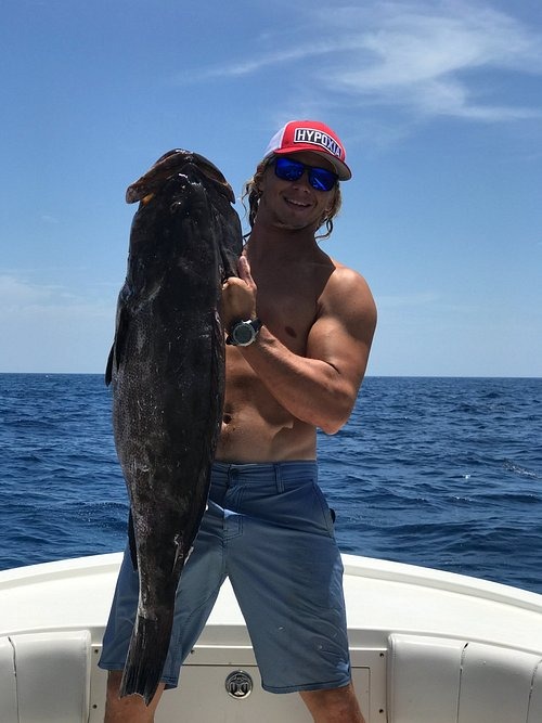Captain Tony holding a large fish caught during a private fishing charter in the Florida Keys.