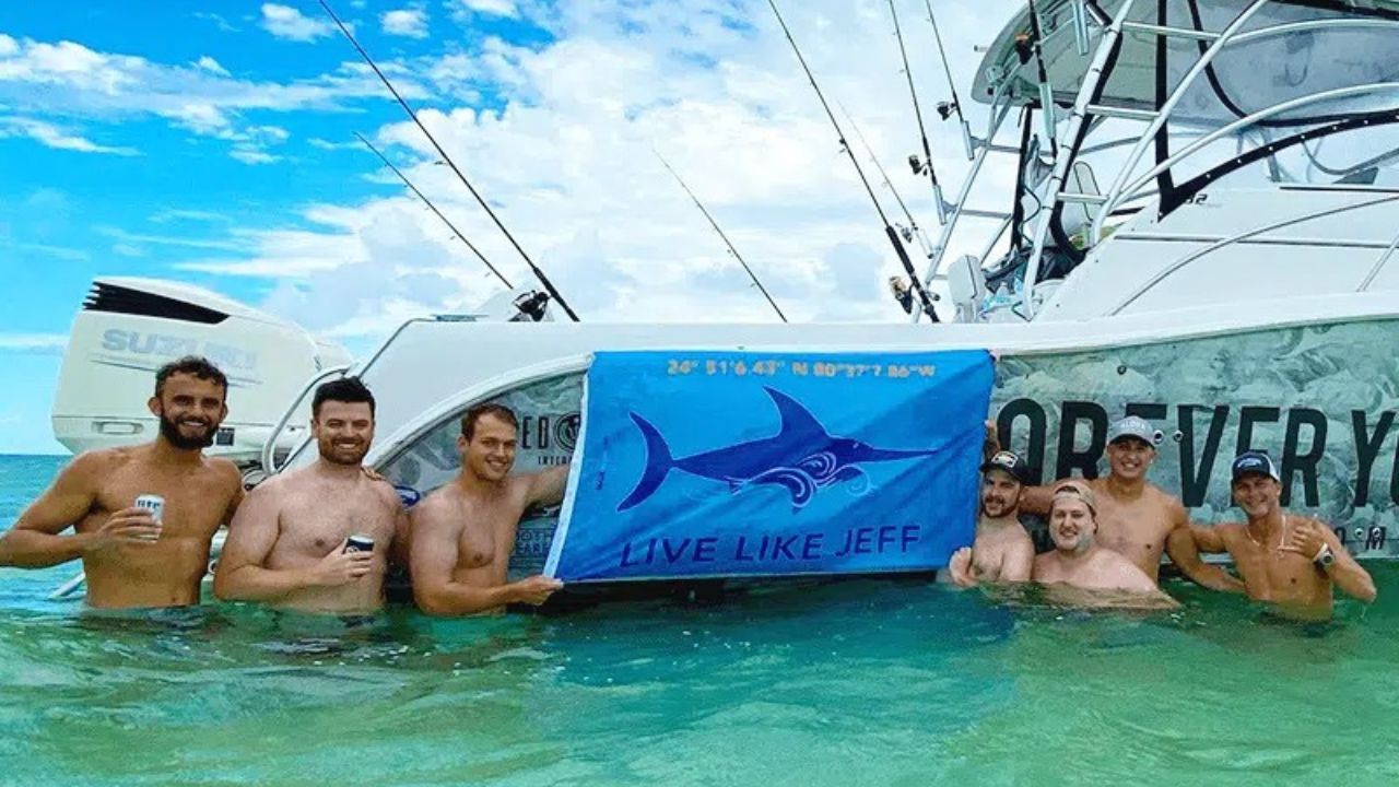 Group enjoying shallow water beside a boat during an Islamorada Sandbar tour.
