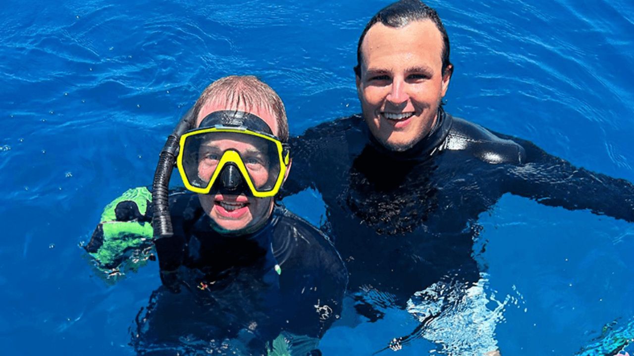 Snorkelers exploring clear blue water and coral reefs in the Florida Keys.